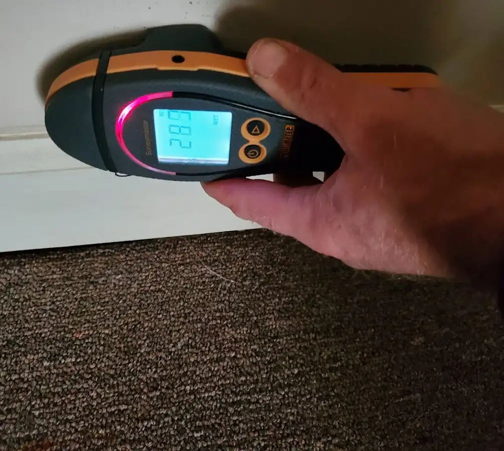 Moisture detection at baseboard during Storm Damage Restoration in Darlington